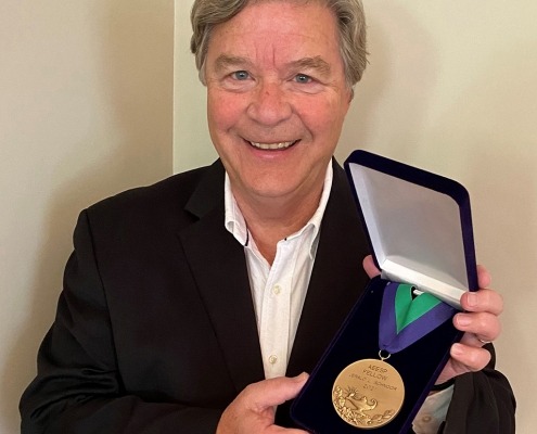 Schnoor poses with an award