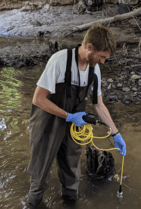 Gregory LeFevre collects water samples