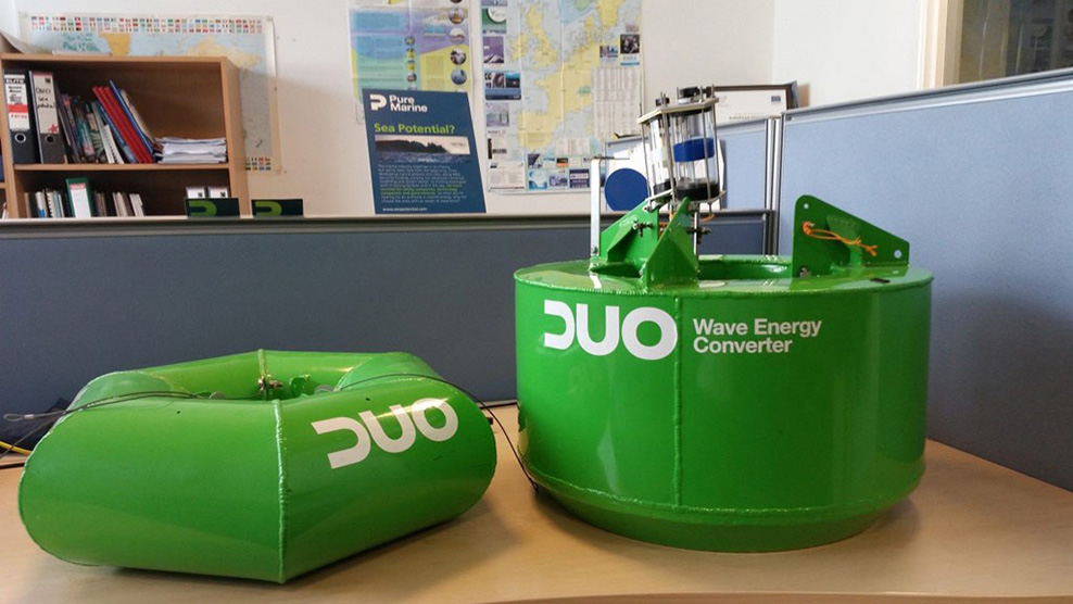 green wave energy converters sit on the floor of a laboratory