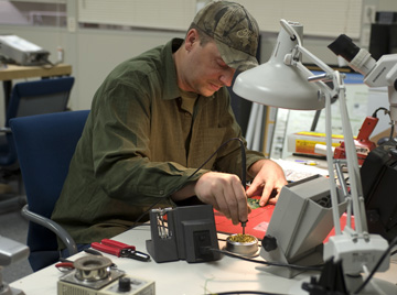 An IIHR worker tinkers with a piece of equipment