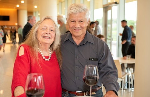 Two people smile for the camera