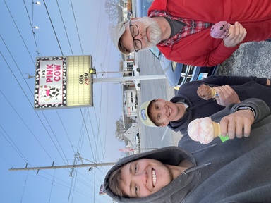 Matthew Kliegl, Dan Gilles, and Nate Young smile while holding their ice cream cones from The Pink Cow