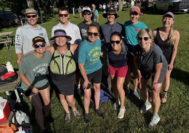 A group of people poses for a photo in a park