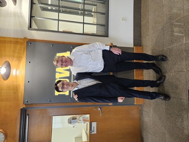 Two men smile and pose for the camera in the Stanley Hydraulics Lab