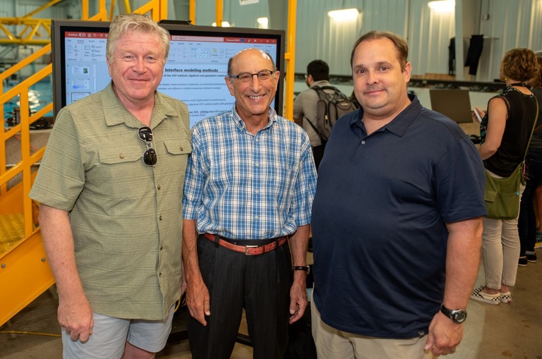 Three people pose for a photo