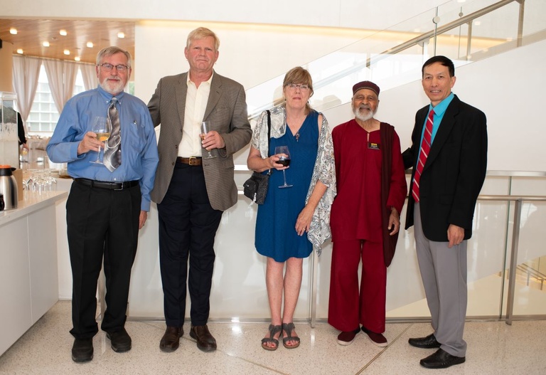 Five people pose for a photo