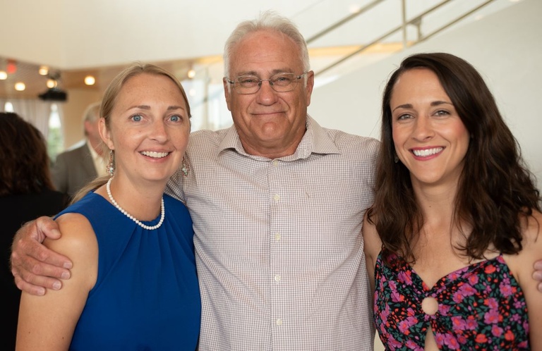 Three people pose for a photo