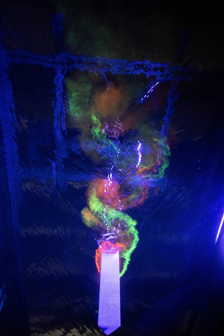 in the dark, Iridescent colors show the flow path of water in a flume