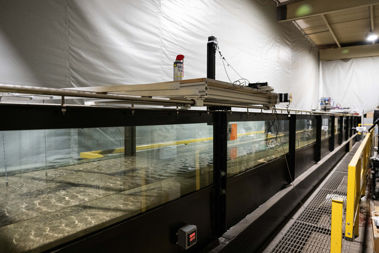 a view looking down the length of the experimental flume with water flowing through