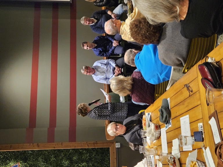 The panel of speakers at the CISWRA event chats to the moderator, smiling