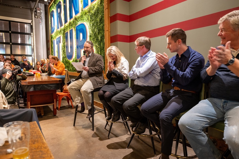 The panel of scientists for the CISWRA presentation sit in a line, looking at the opening speaker and clapping