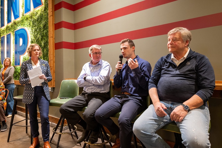 The CISWRA panel speakers look at Elliot Anderson as he talks to the crowd