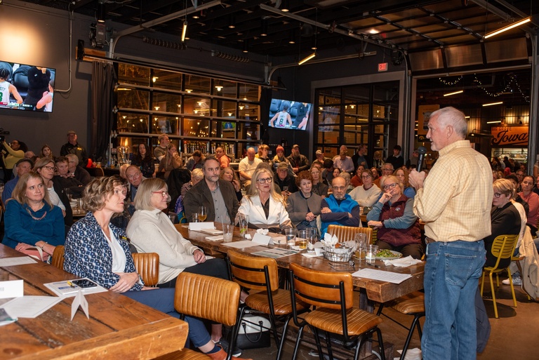 The final speaker gives a call to action to the crowd at Big Grove Brewery