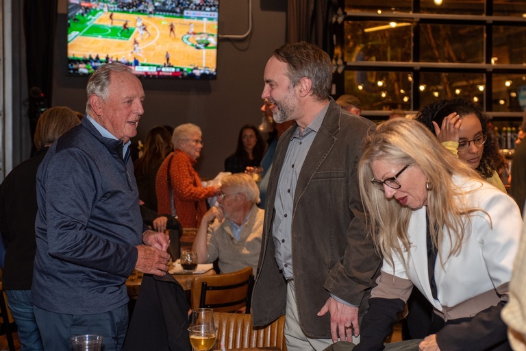Members of the CISWRA panel speak to members of the audience after the event