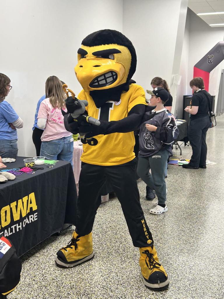 Herky holds a dash stuffed animal 