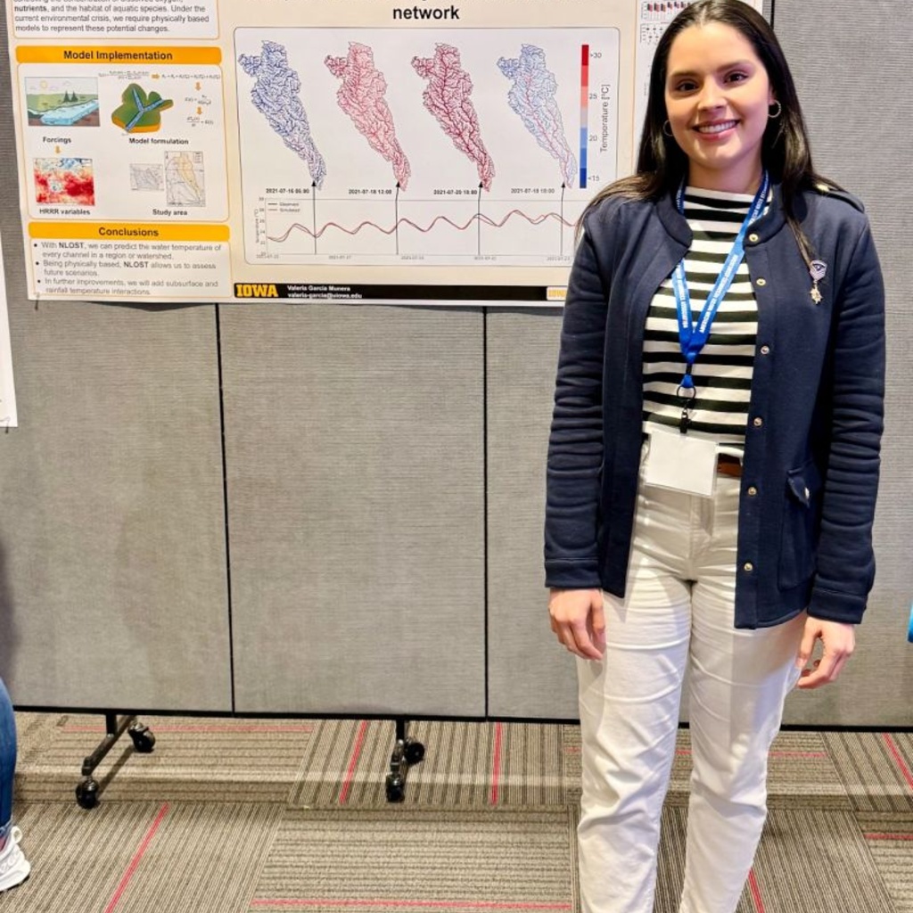 Valeria Garcia stands by a poster