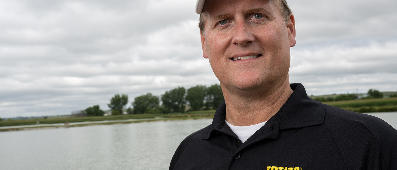 Craig Just in front of a large body of water on a grey day