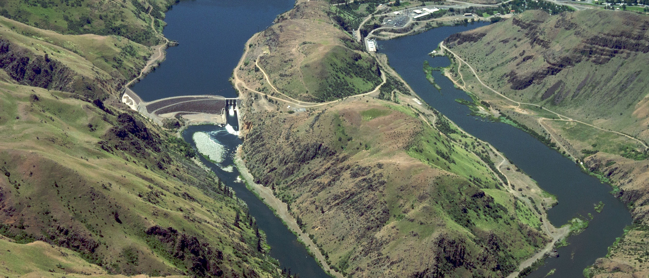 a very high aerial image of Hells Canyon with the river twisting through the landscape