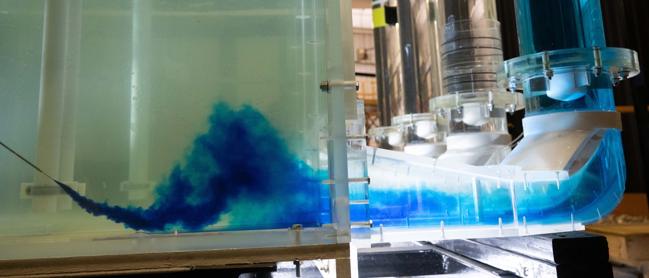 A shot of the dubuque bee branch pump station from the side, with a blue liquid being shot into the tube to see flow 