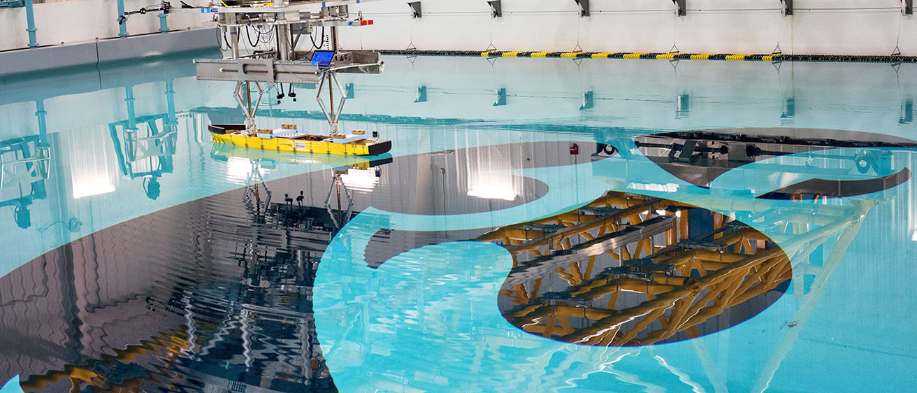 The IIHR wave basin with a ship being tested for its maneuverability 