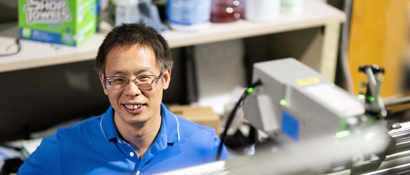 Cong wang smiles, pictured behind the flume