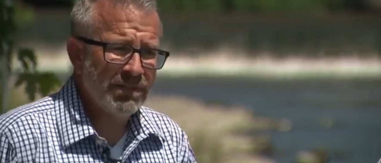 David Cwiertny looks concerned as he discusses Iowa's environmental contaminants with the Iowa River in the background