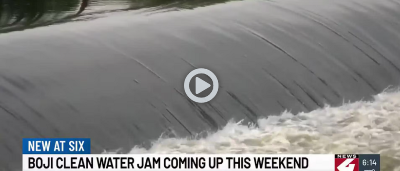 Screenshot from KTIV showing water flowing over a dam