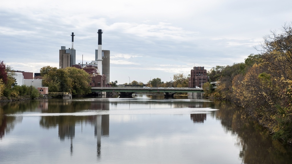 A view of the Iowa River with the Power Plant and Stanley Hydraulics Lab reflected on the calm water surface