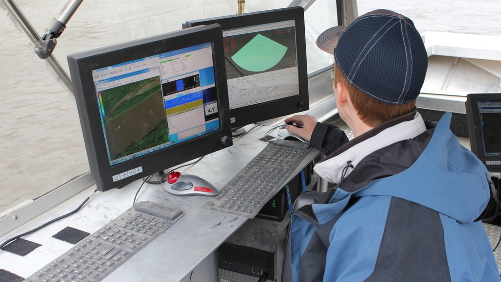 an IIHR employee performs bathymetry on the river