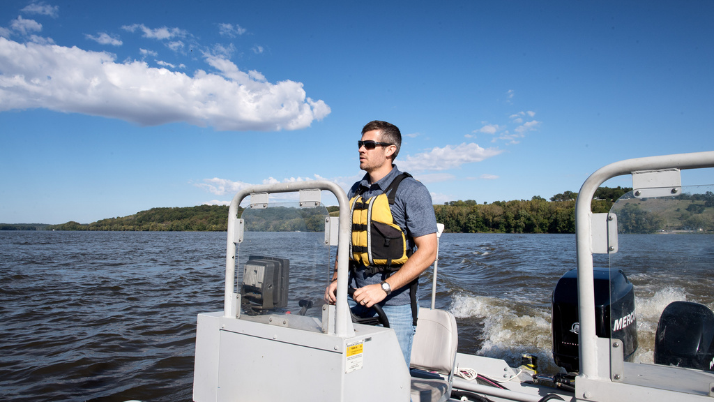 IIHR assistant director Troy Lyons navigates one of the IIHR research boats on a lake