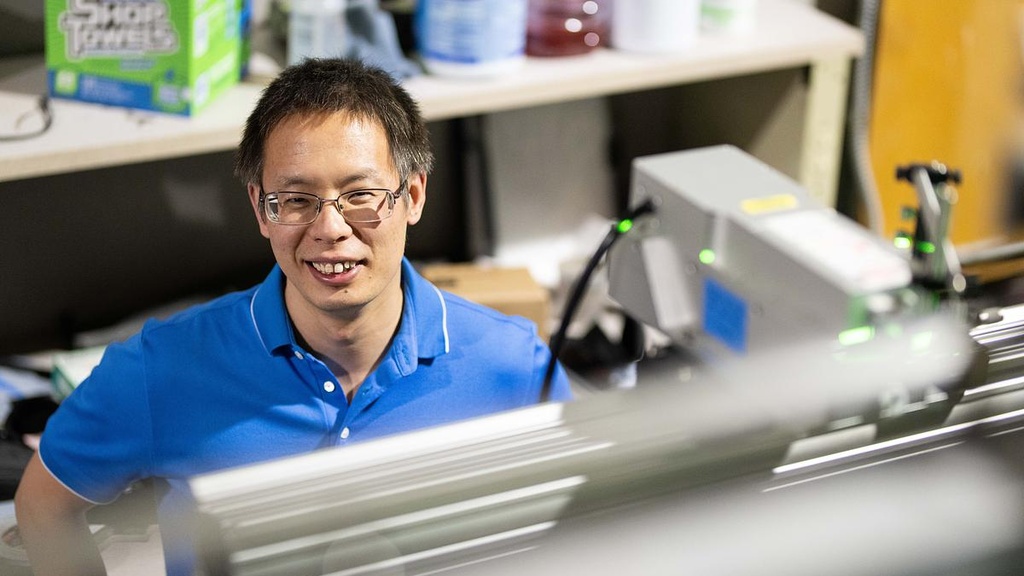 Cong wang smiles, pictured behind the flume
