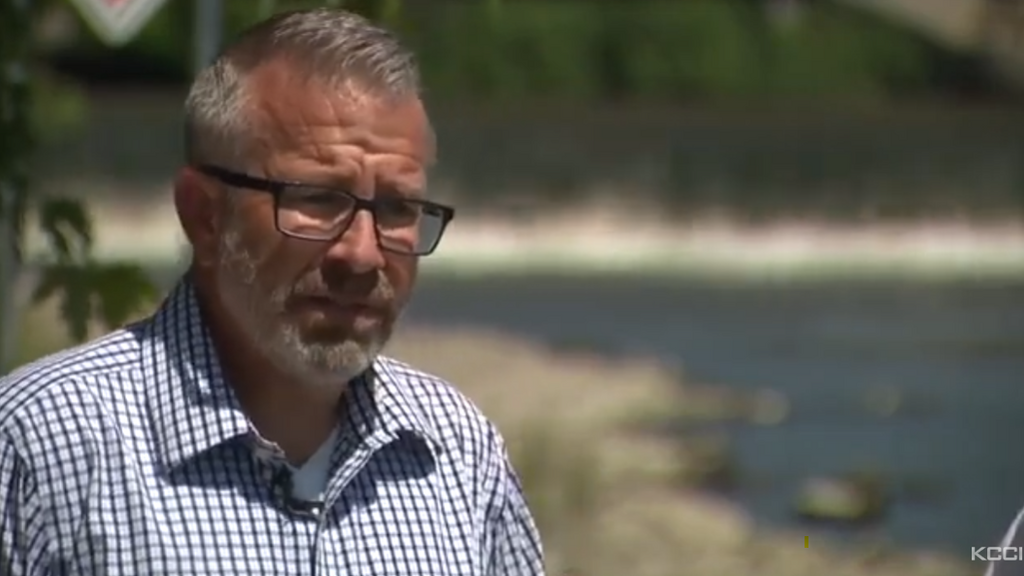 David Cwiertny looks concerned as he discusses Iowa's environmental contaminants with the Iowa River in the background