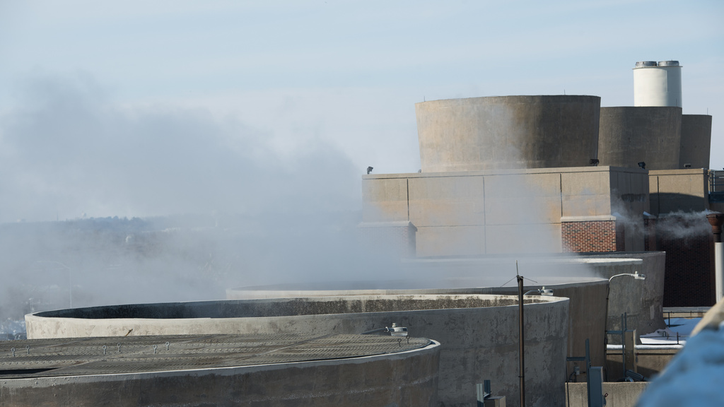 Steam billows from a power plant