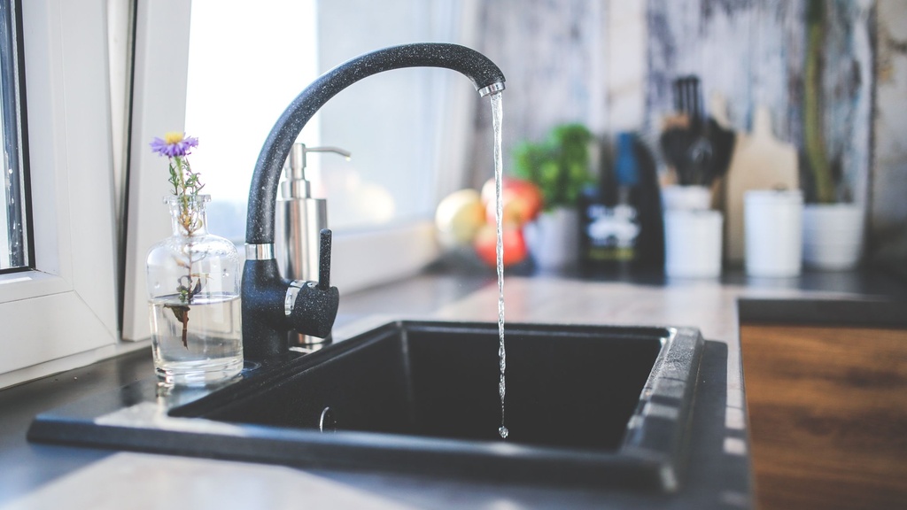 A kitchen faucet with water running